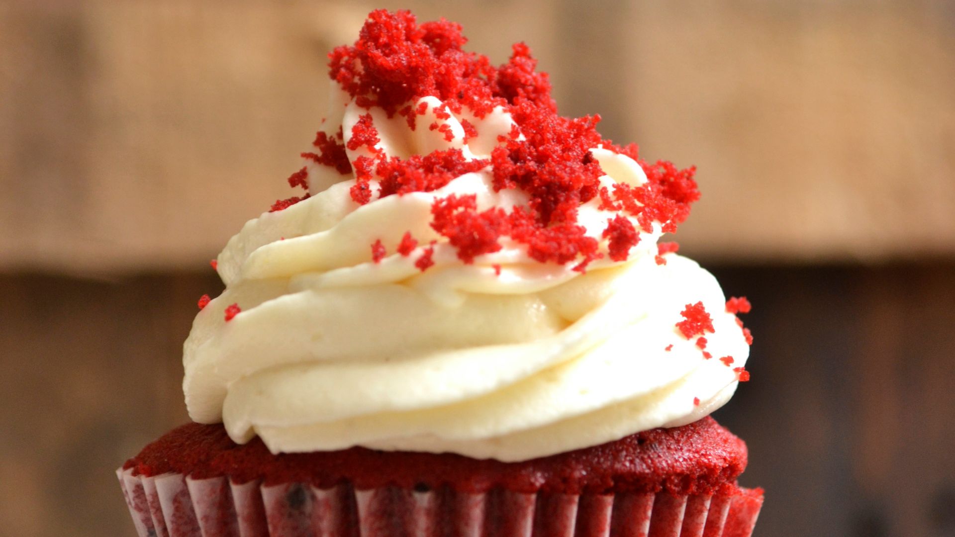 white and red cupcake with white icing on top