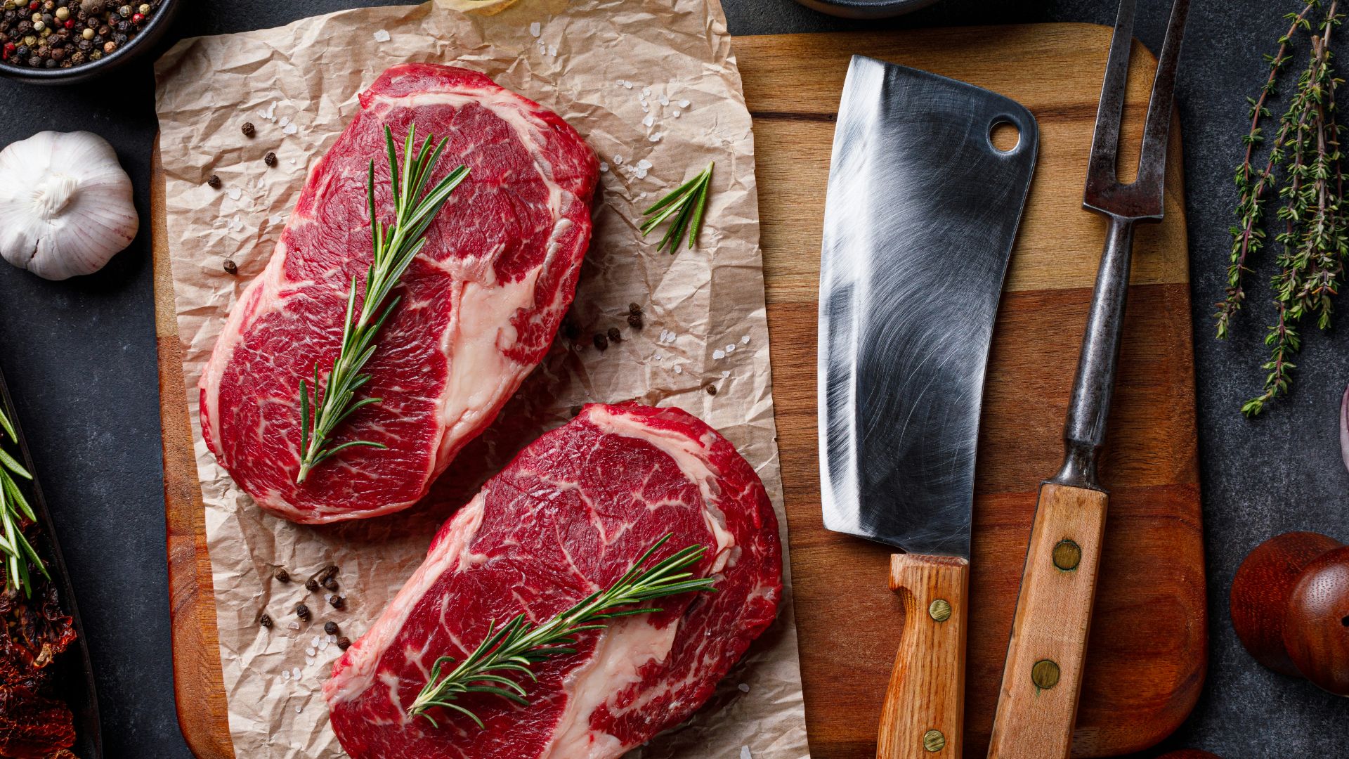 a cutting board topped with raw meat next to a knife