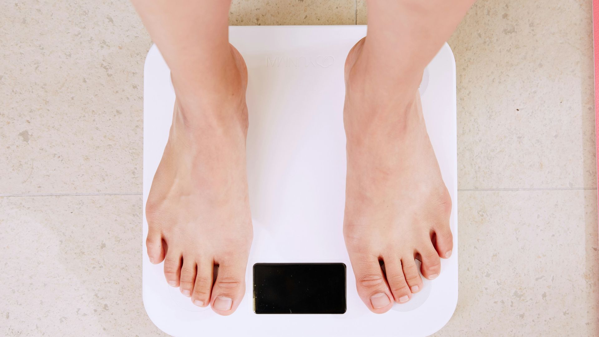 person standing on white digital bathroom scale