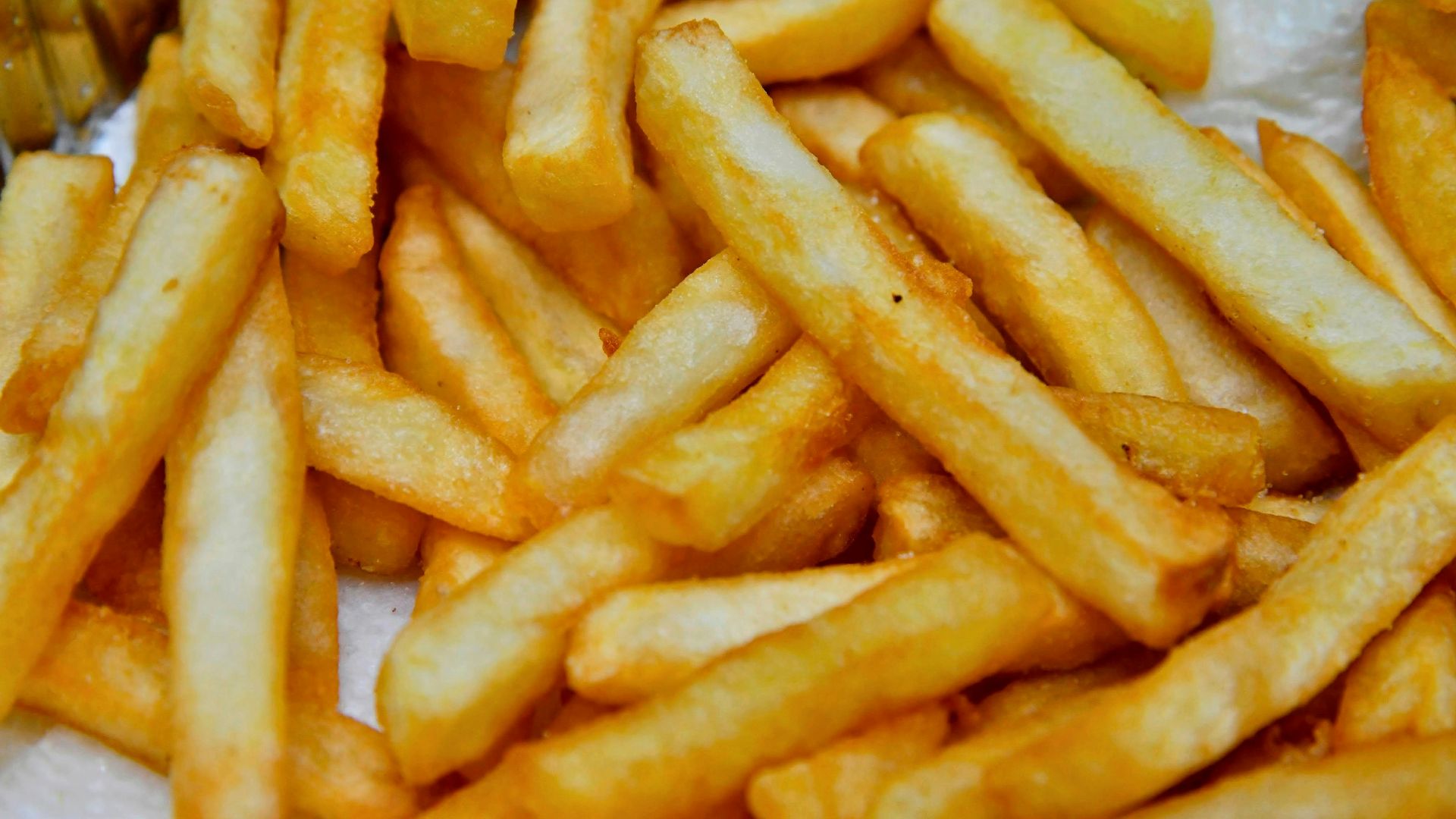 a pile of french fries sitting on top of a table