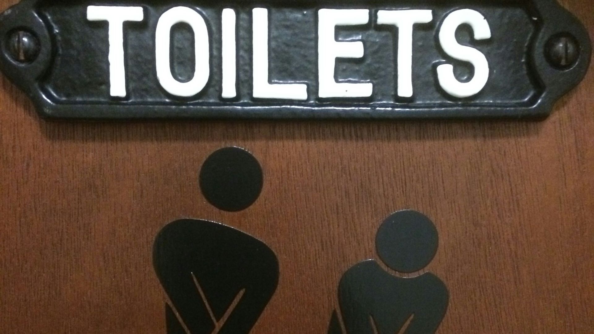 a toilet sign with a picture of a man and a woman