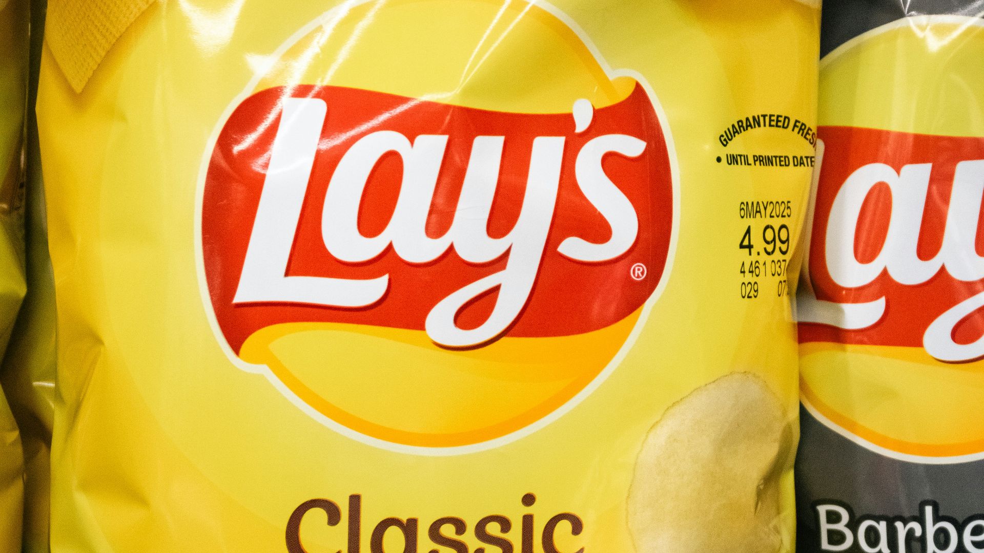 A bag of lays classic potato chips.