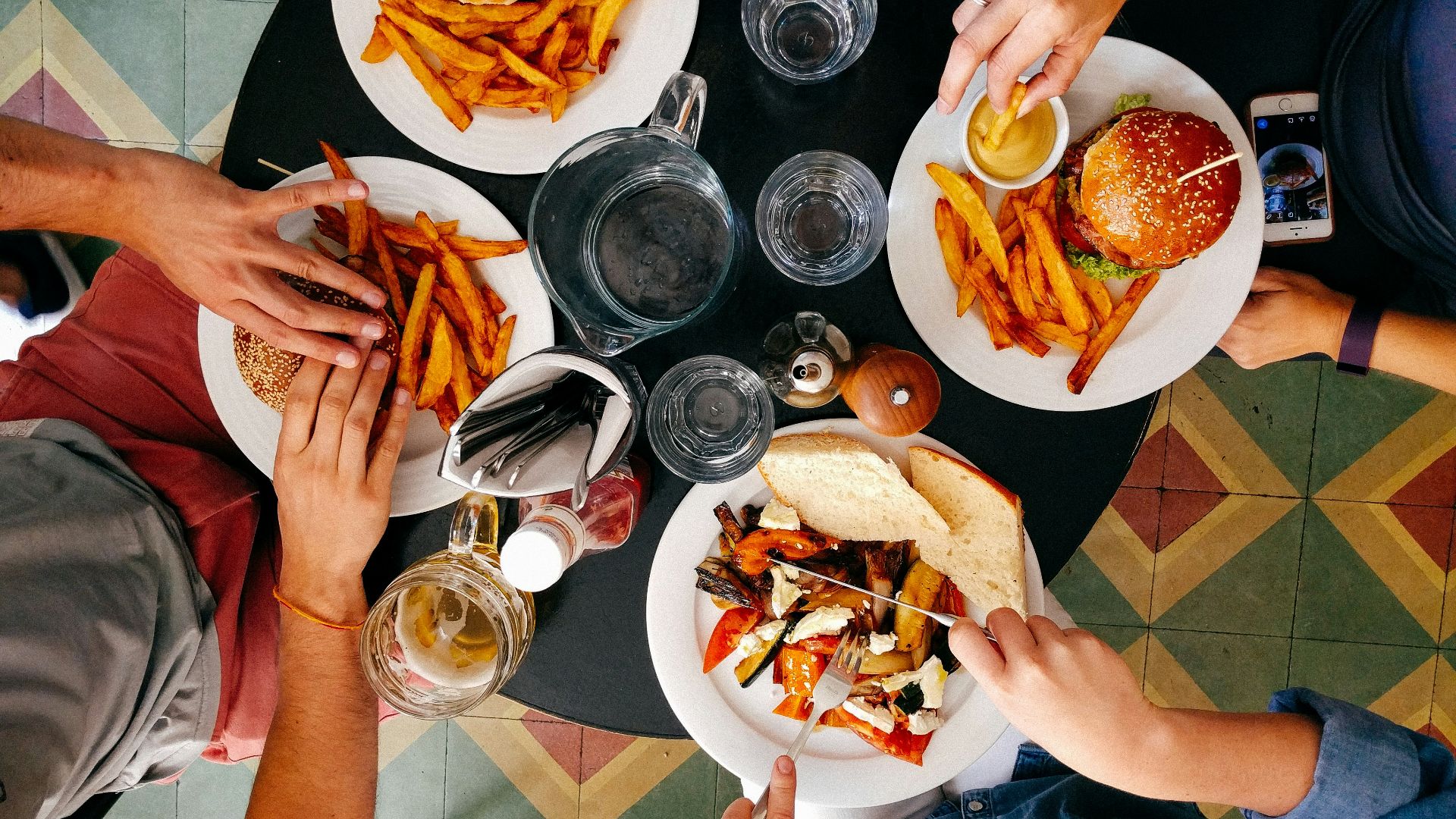 four person earring on black wooden table