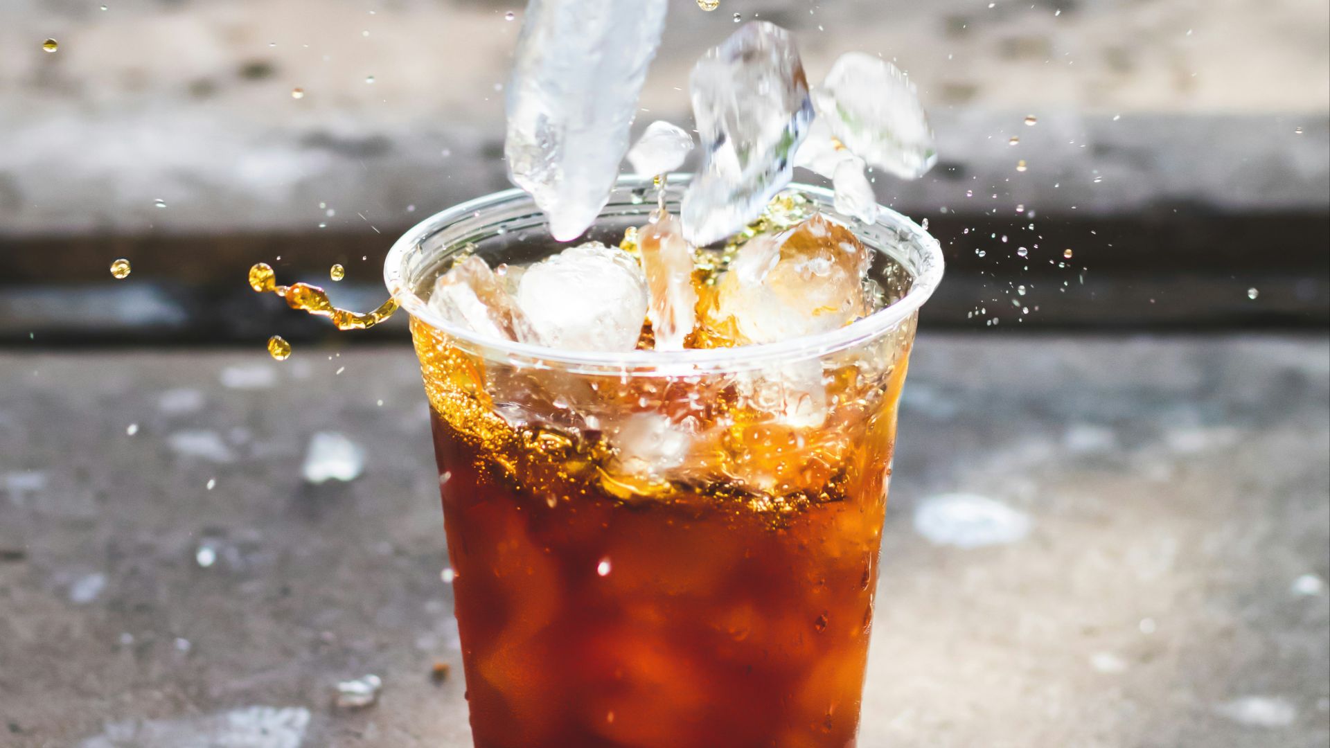macro photography of dropping ice cube in cup