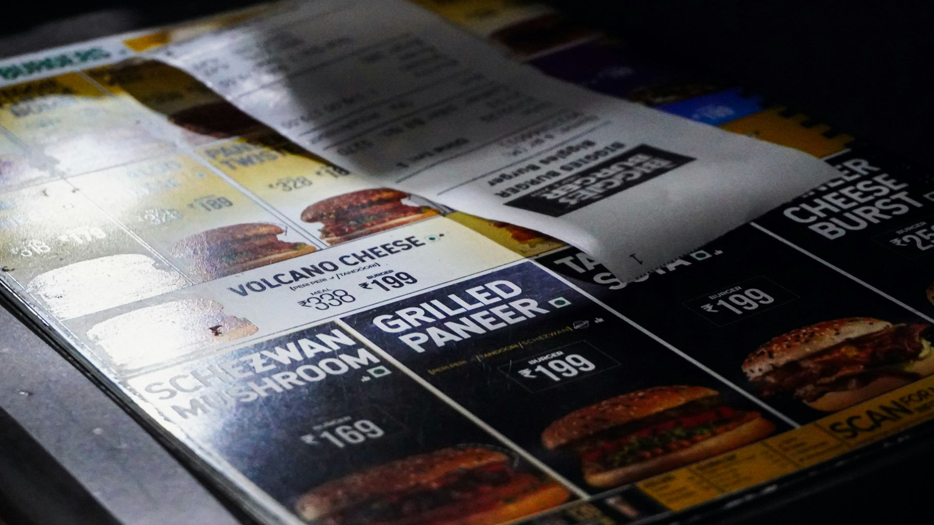 Menu with burgers and prices displayed prices