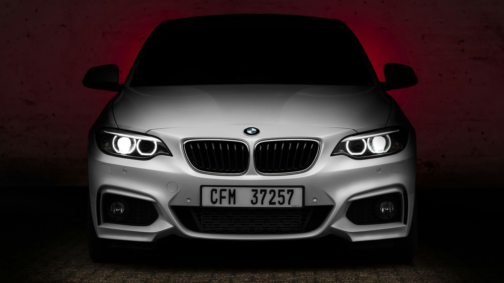 blue bmw m 3 on red floor