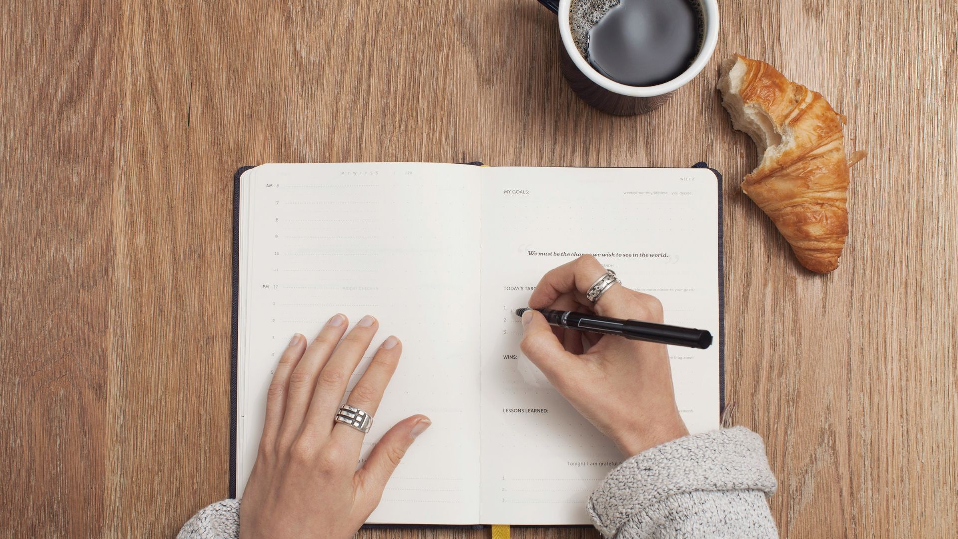 person writing on a book