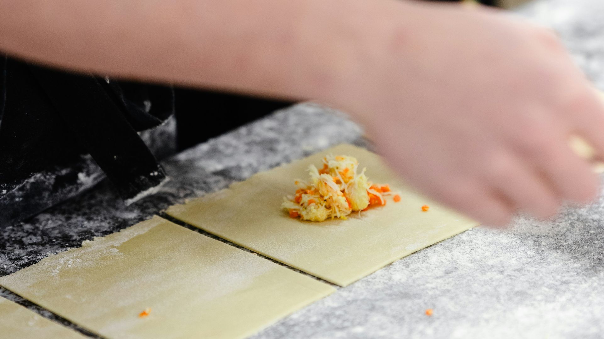a person in an apron making food on a counter