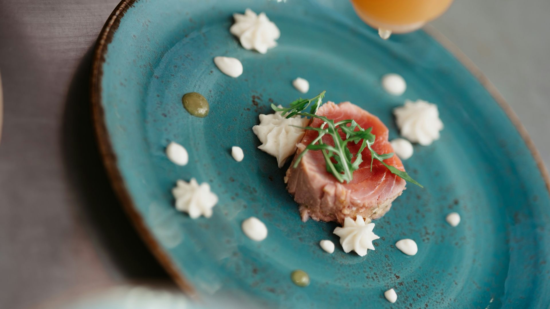 a blue plate with a small piece of food on it