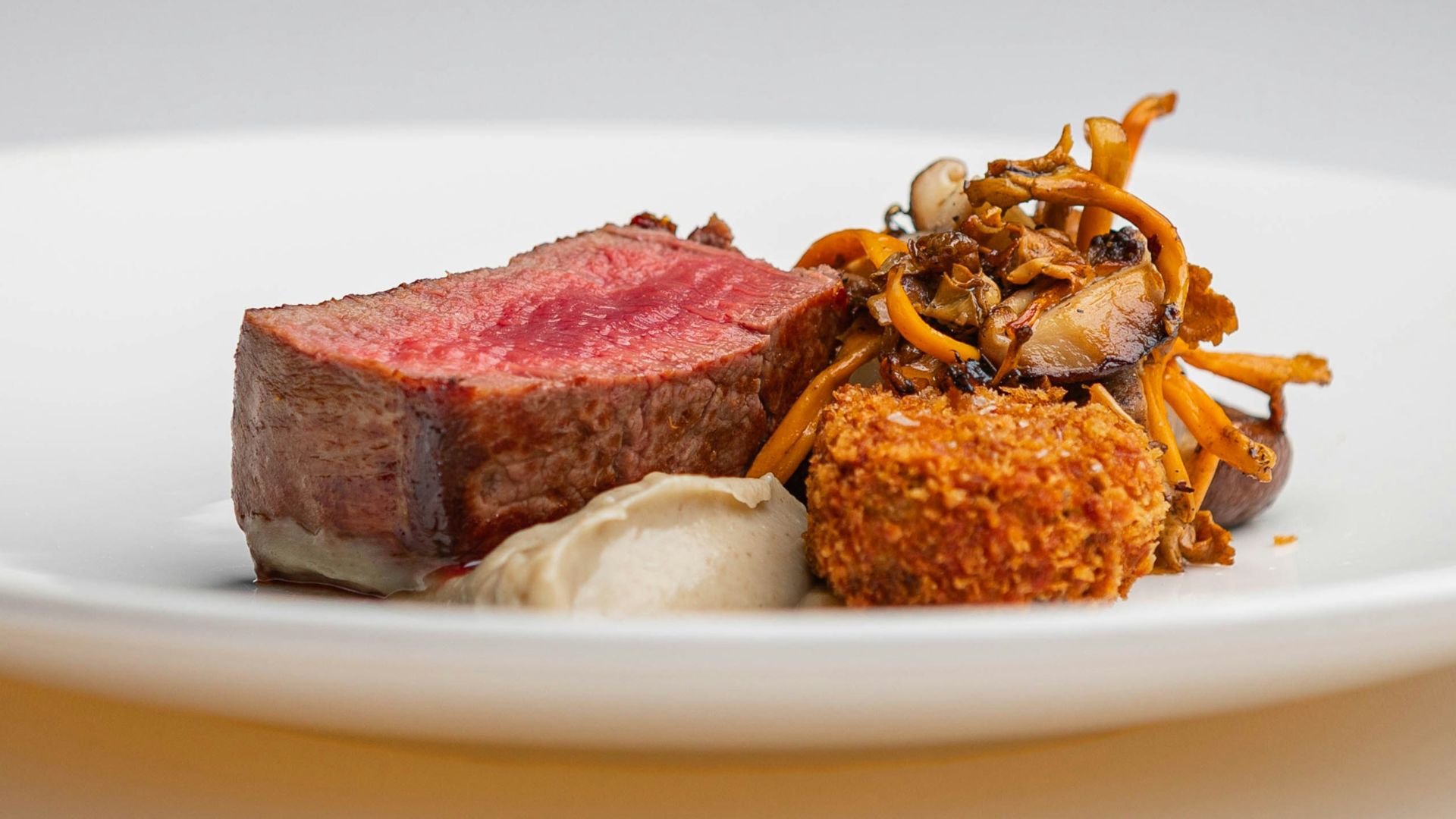 a white plate topped with meat and vegetables