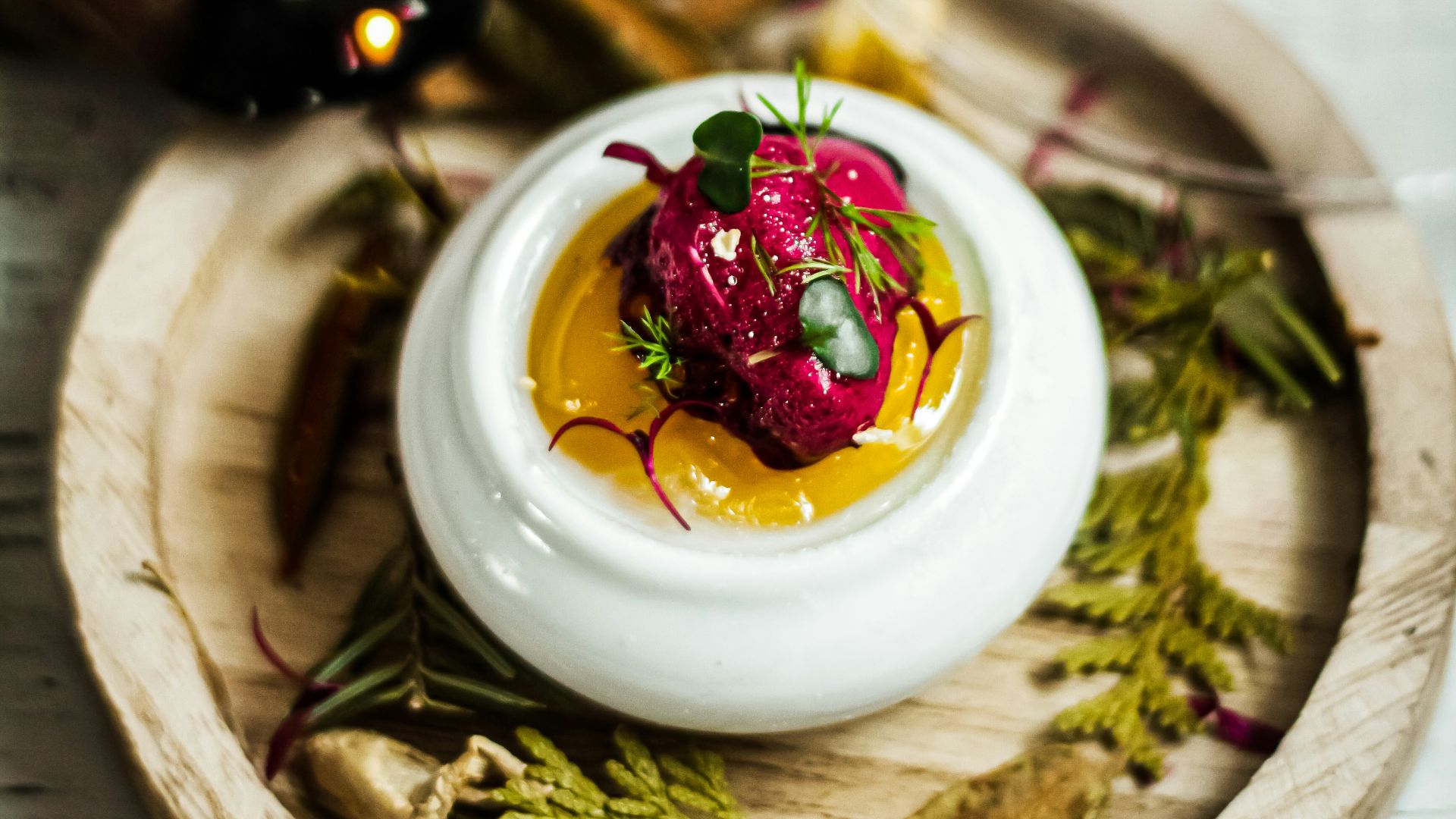 a small white bowl filled with food on top of a wooden tray