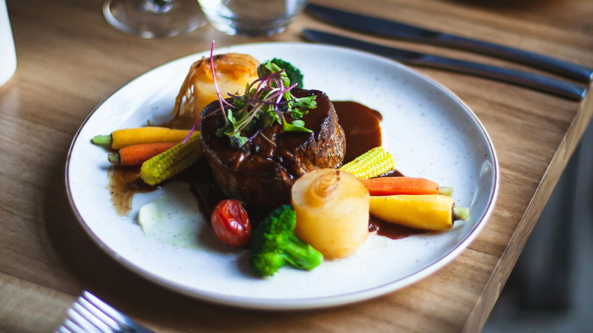 a plate of food on a wooden table