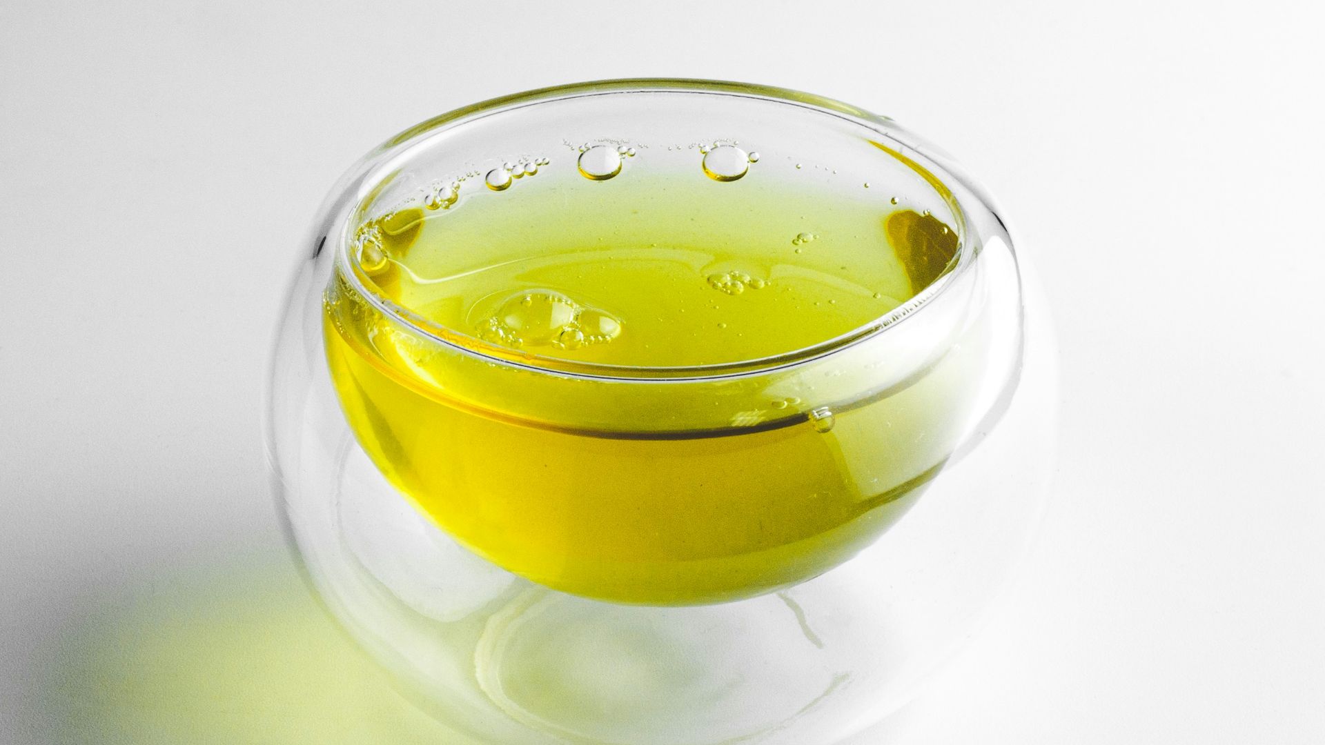 clear glass cup with yellow liquid