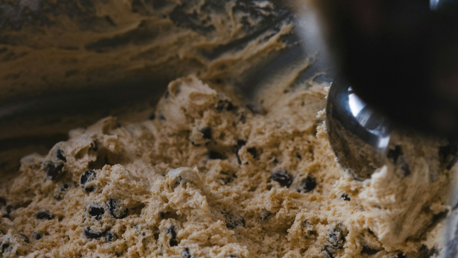 A person stirring a bowl of food with a spoon