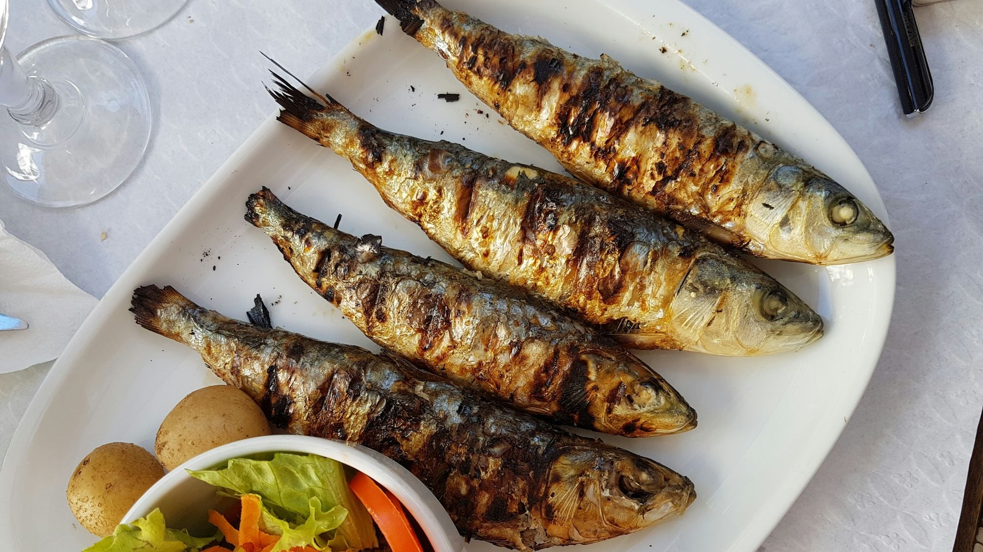 grilled fish with vegetable salad on white ceramic plate