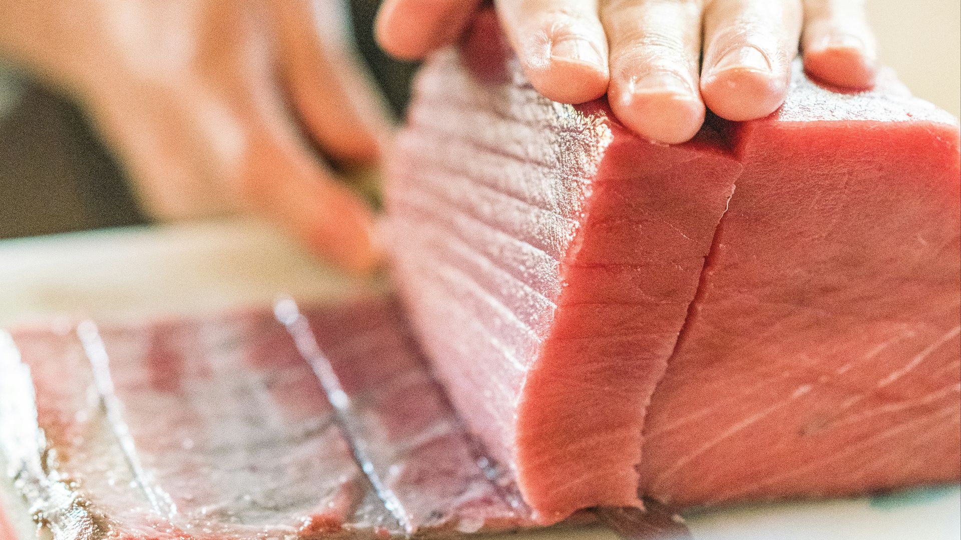 a person holding a piece of raw meat