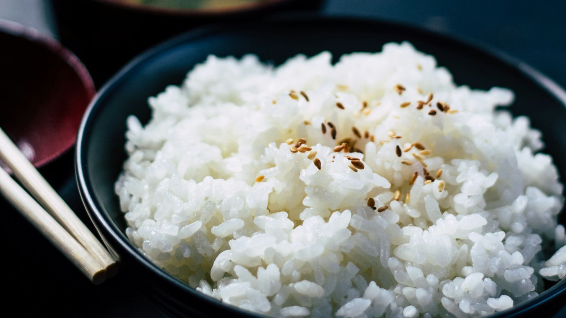 rice with sesame in black bowl