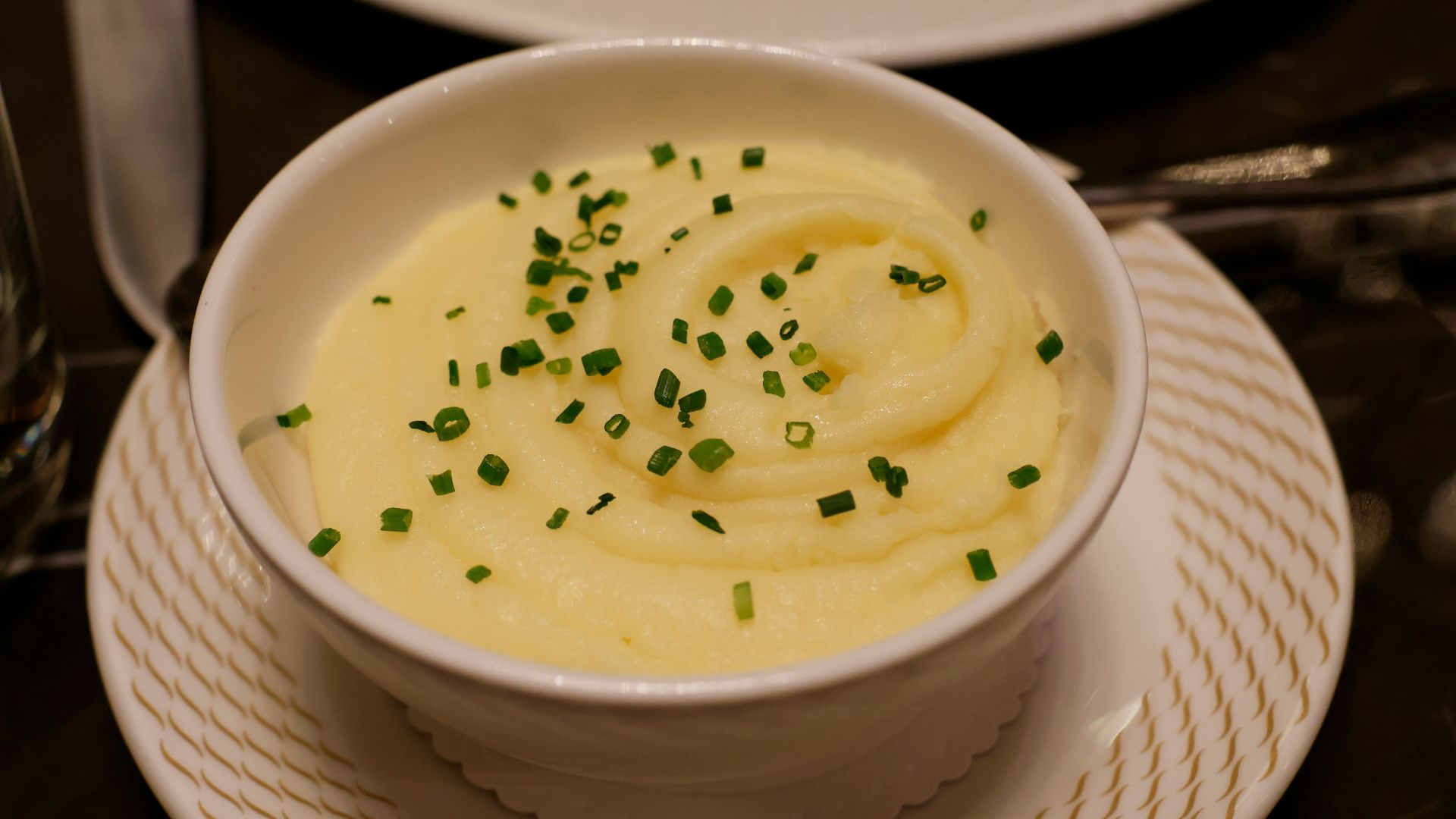 a bowl of mashed potatoes topped with chives