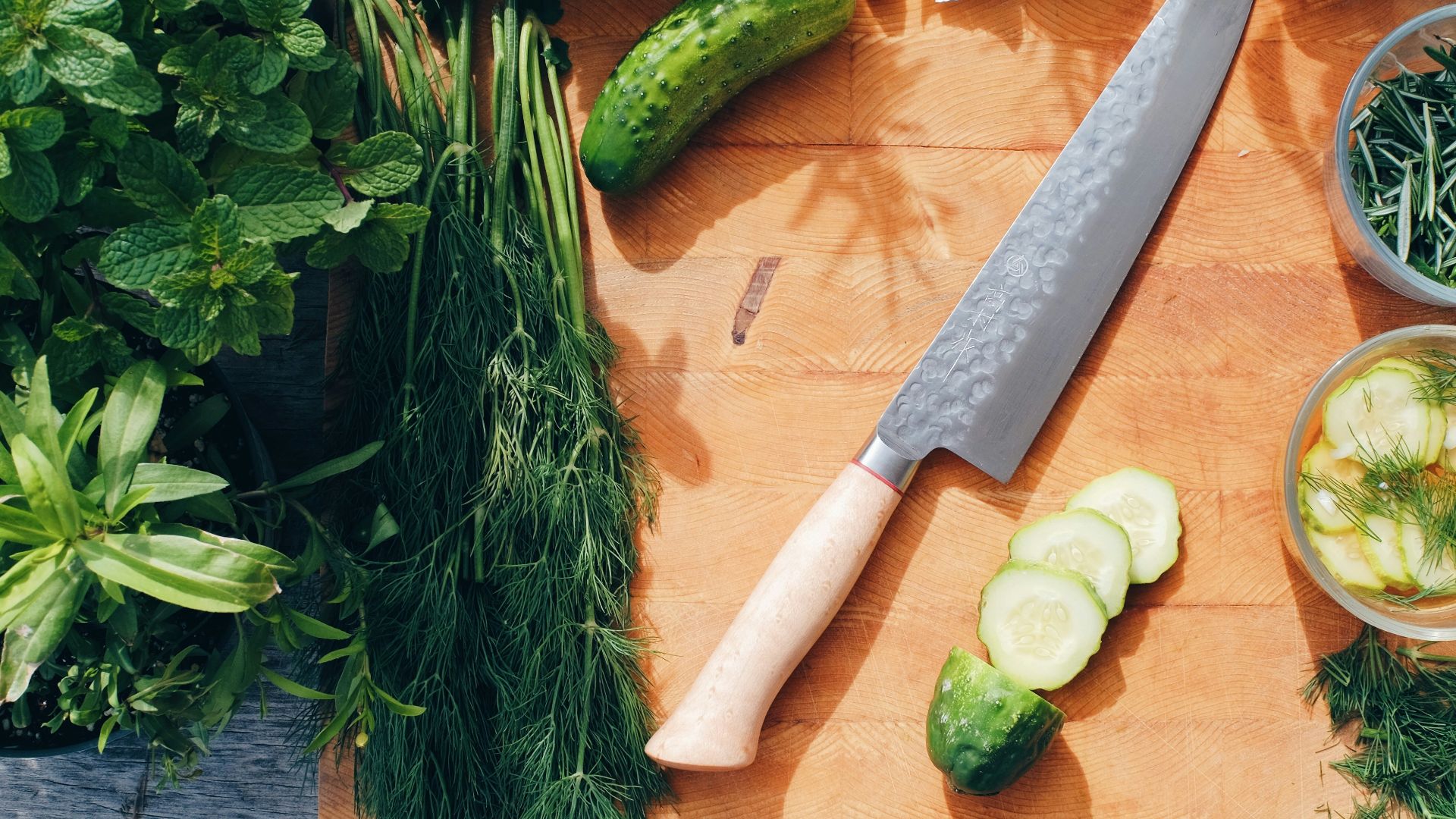 sliced cucumber and green vegetable on brown wooden chopping board