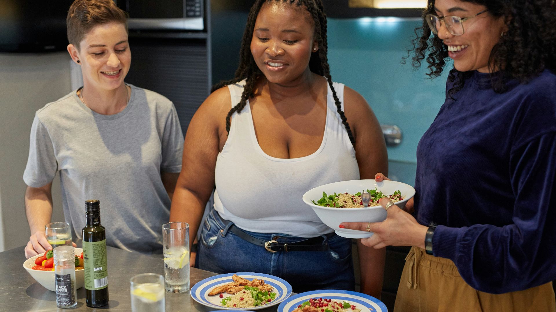 a group of people preparing food in a kitchen