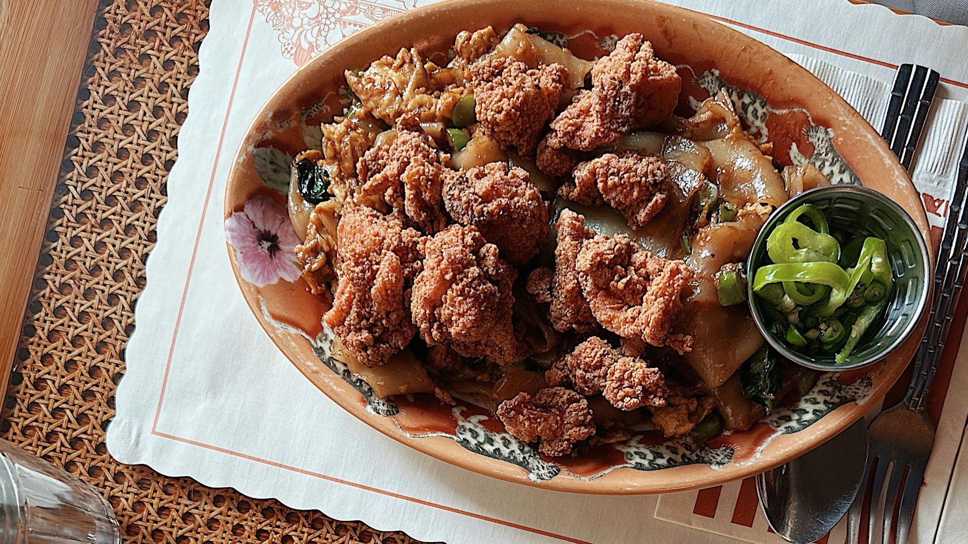 two plates of food on a table with utensils