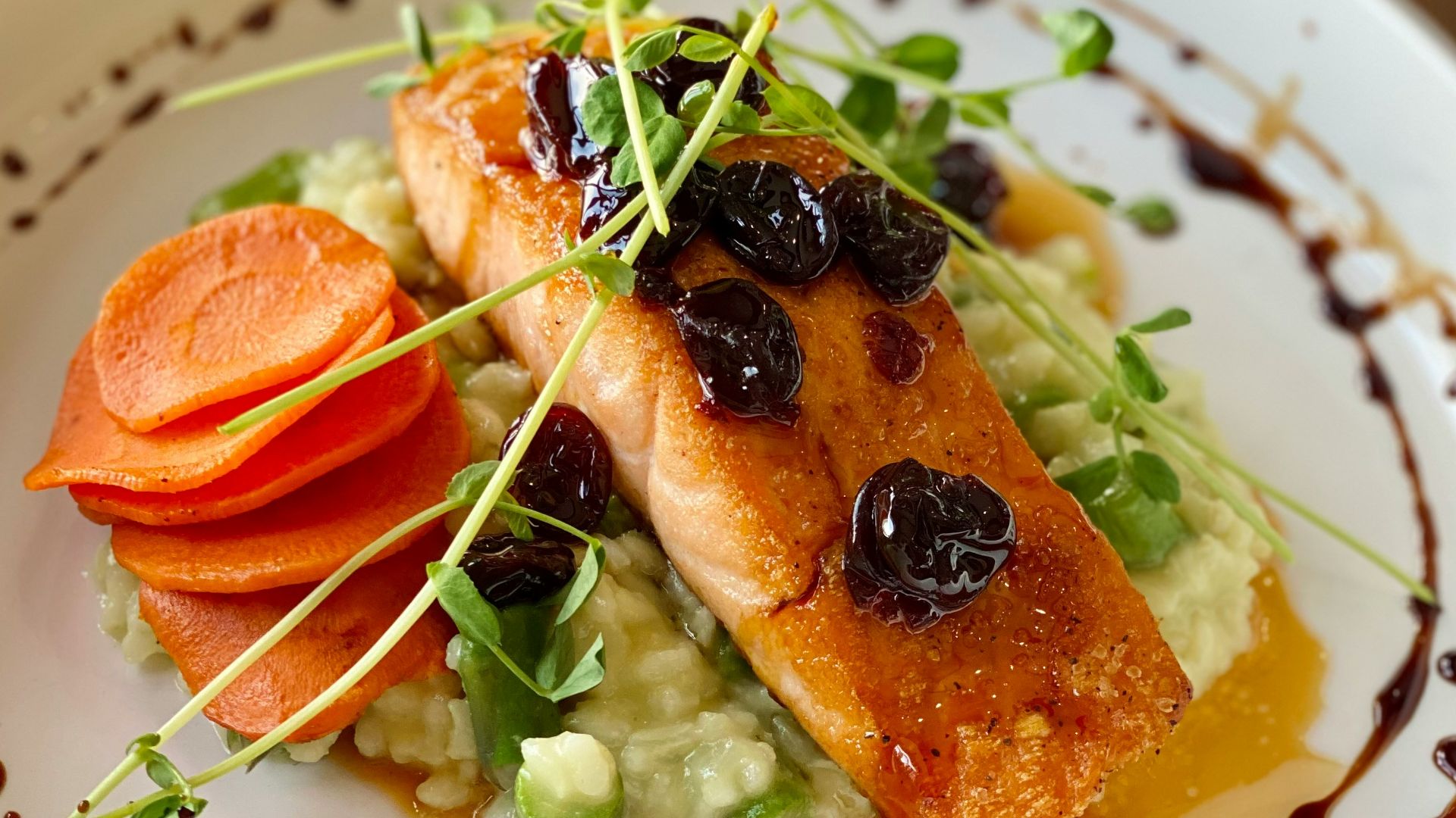 a white plate topped with fish and veggies