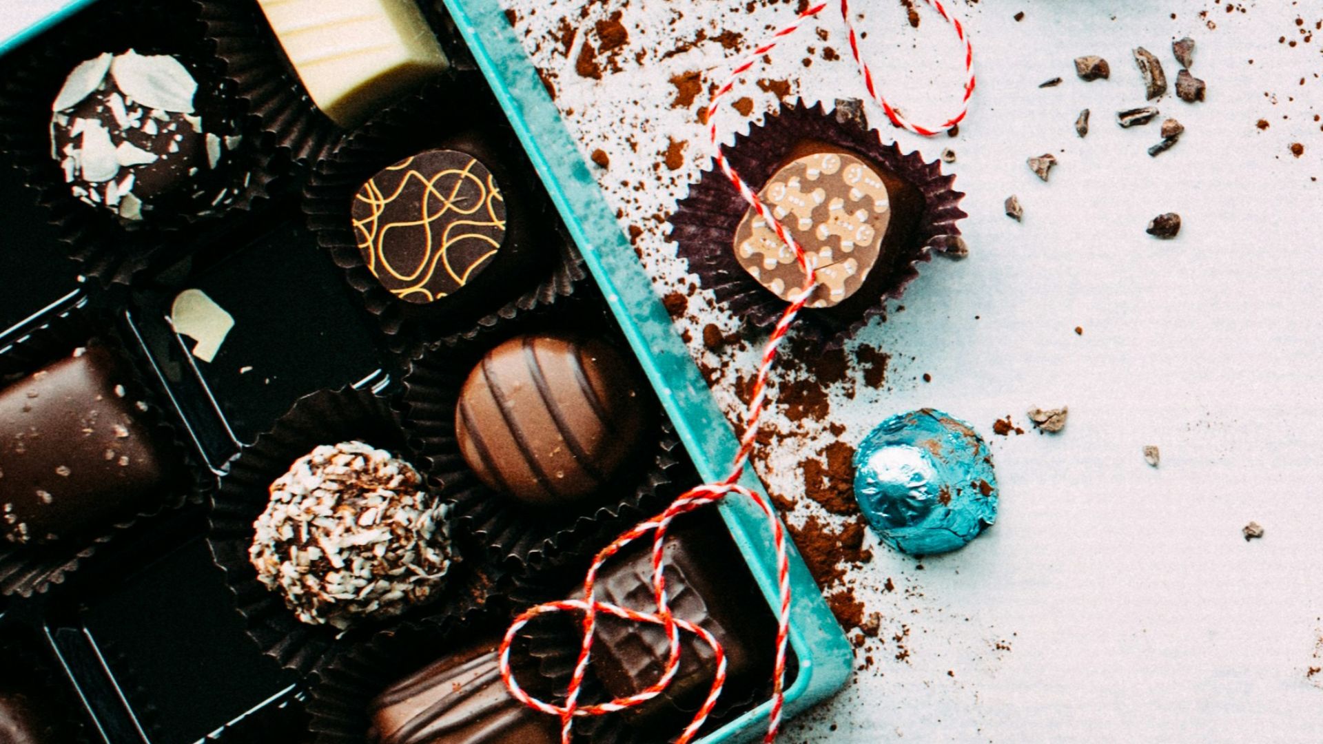 chocolates with box on white surface
