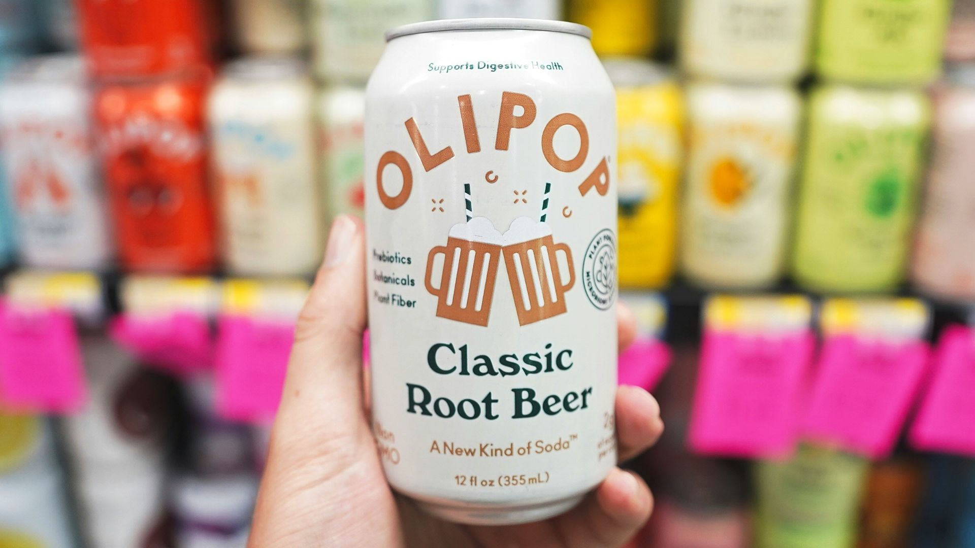 A person holding up a can of beer