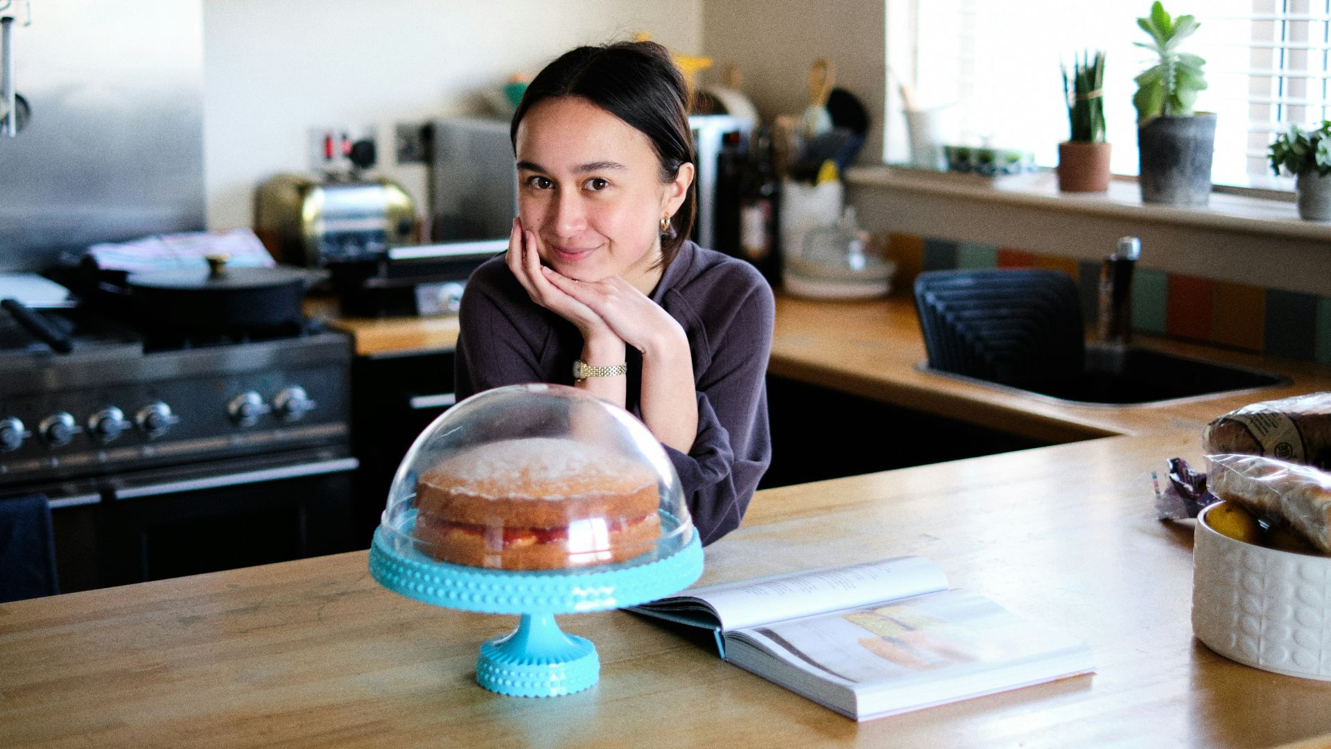woman in pink long sleeve shirt sitting at the table