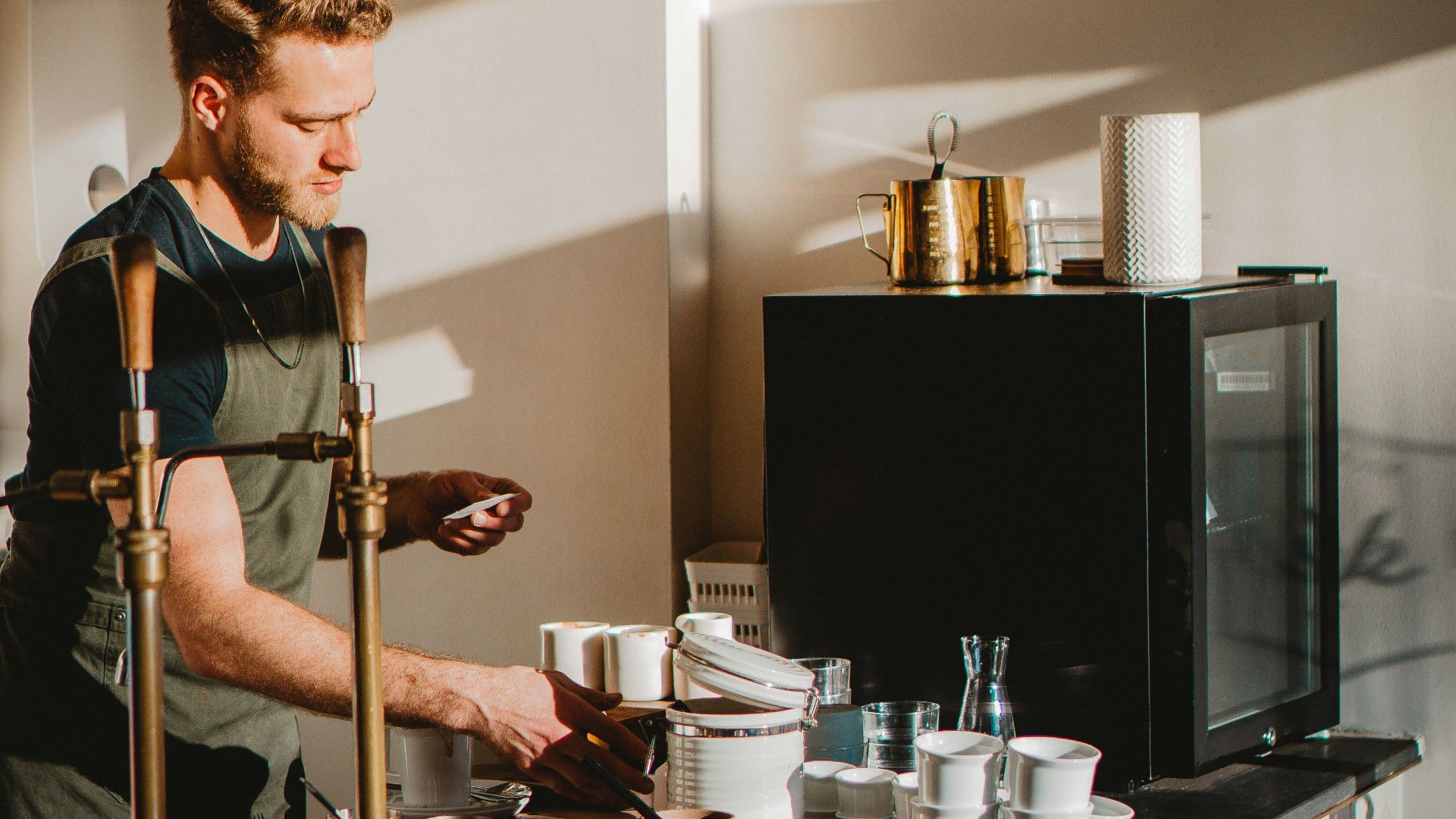 man in black and white polo shirt playing guitar