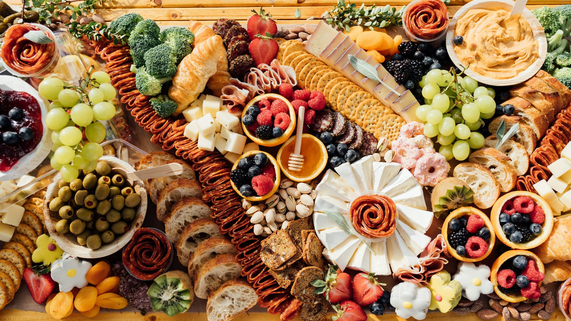 a wooden table topped with lots of different types of food