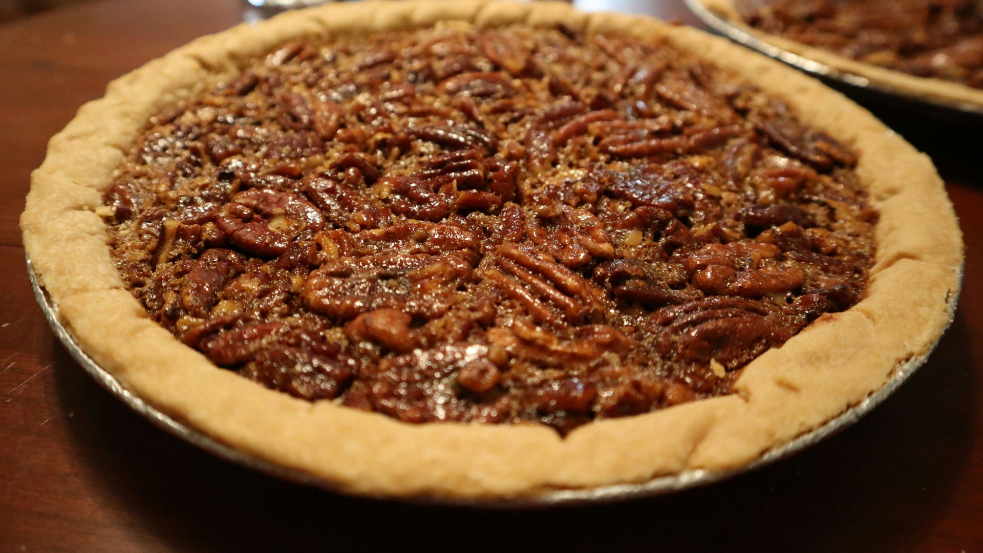 A pecan pie sitting on top of a wooden table