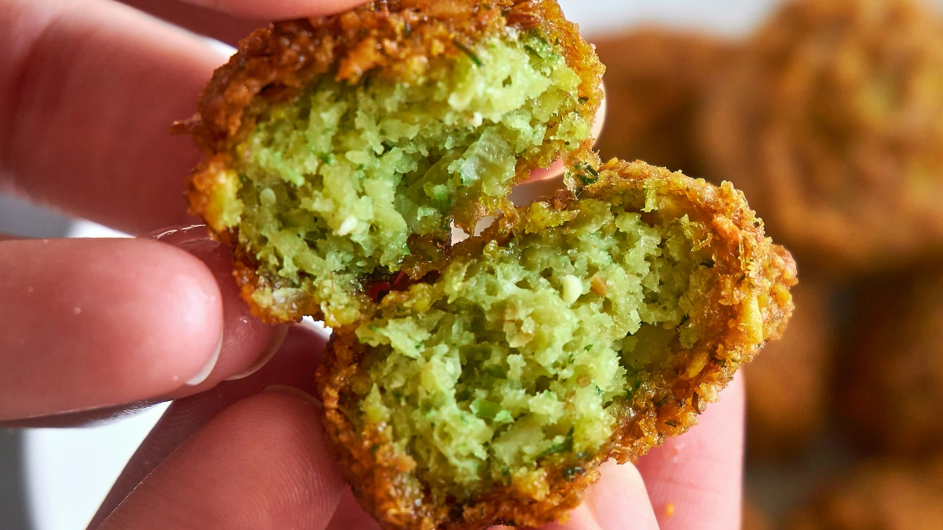 person holding brown and green food
