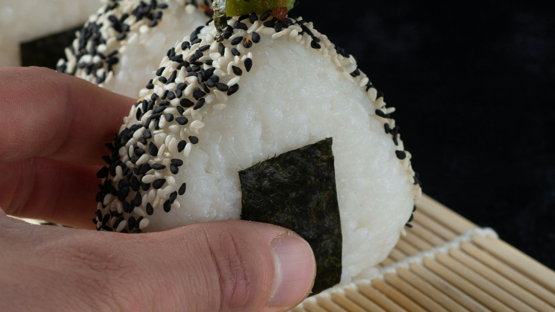 person holding white and brown cake