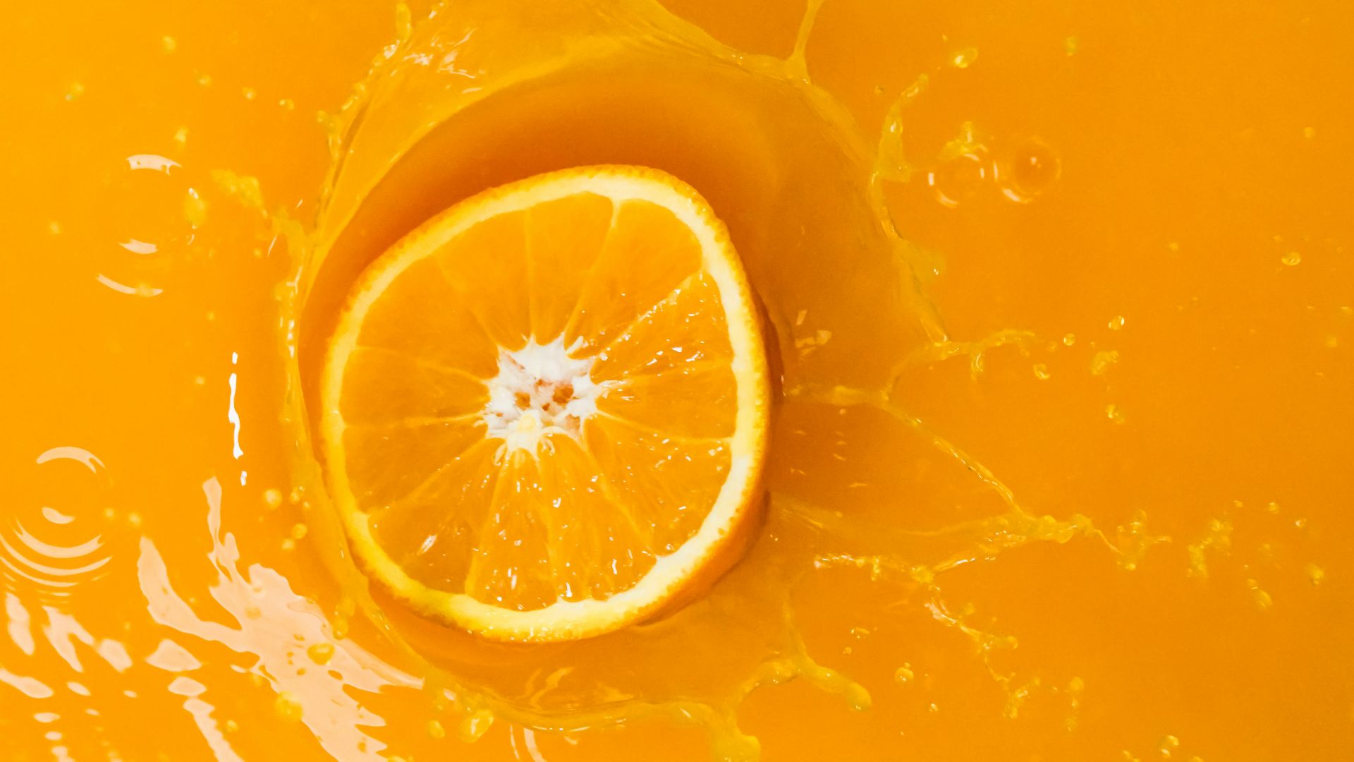 a slice of orange sitting on top of a yellow bowl