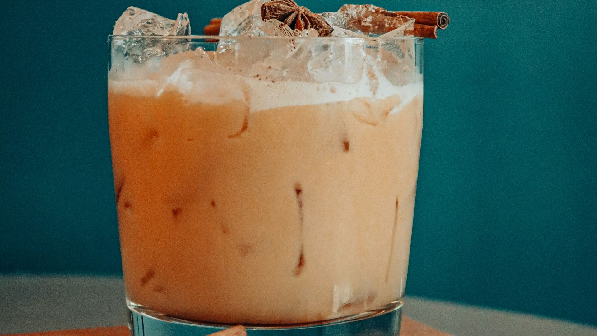 clear drinking glass with brown liquid and ice