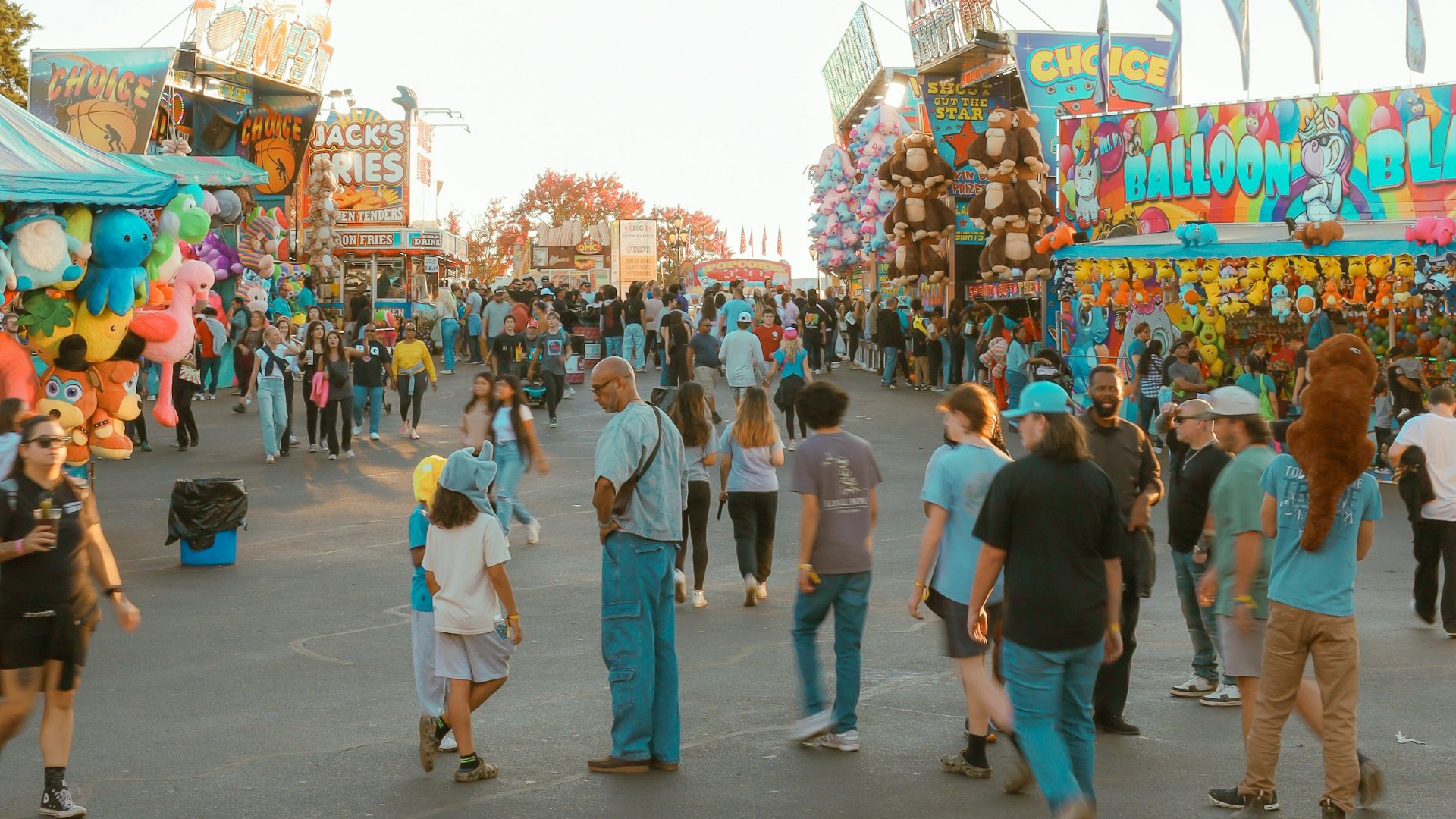A crowd of people walking around a carnival