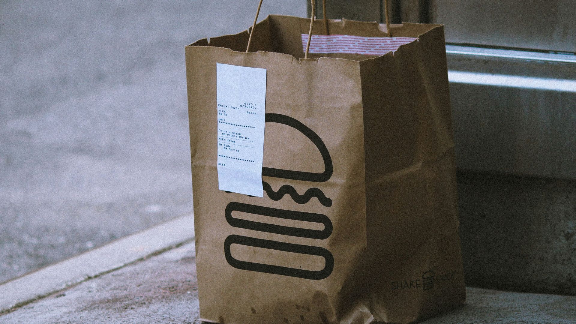 brown paper bag on gray concrete floor
