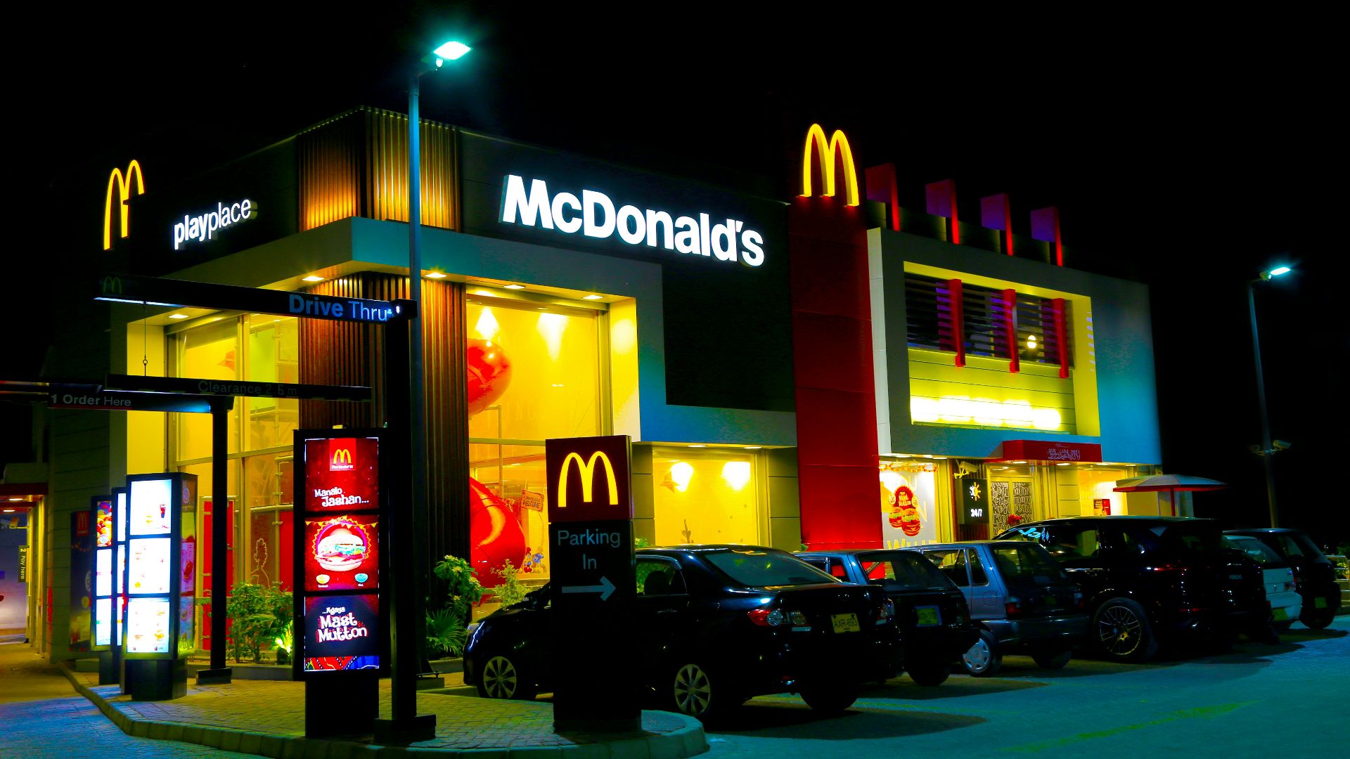 cars parked in front of UNKs restaurant during night time