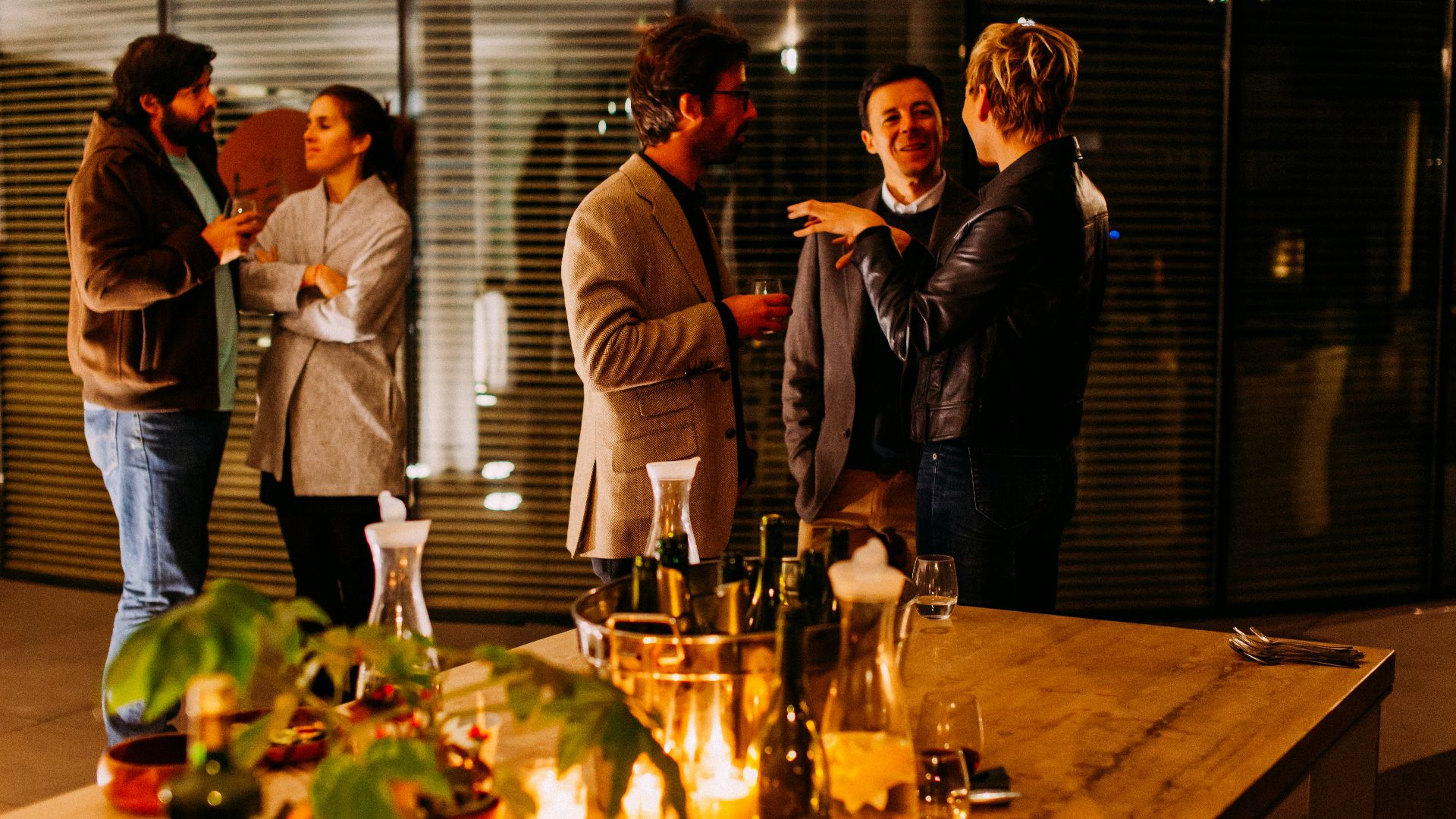 five person standing while talking each other
