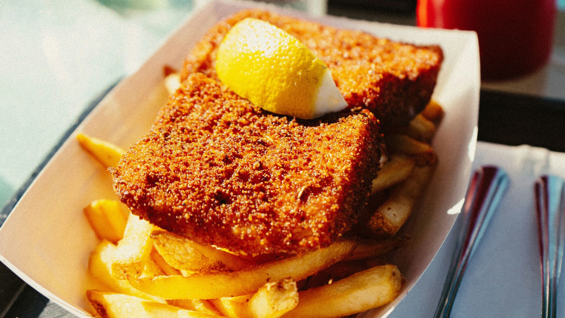 a plate of french fries with a lemon on top