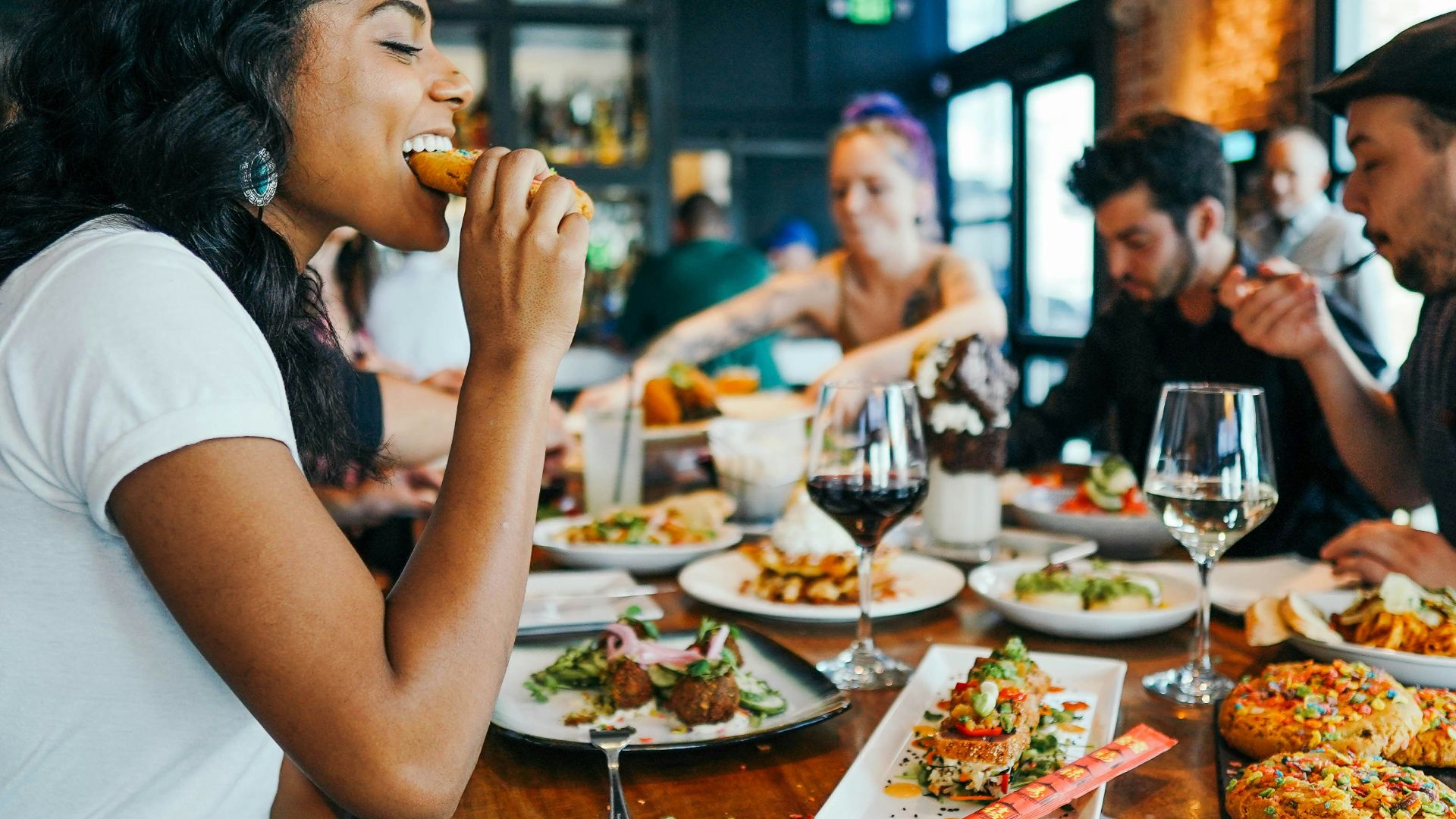 woman in white shirt eating