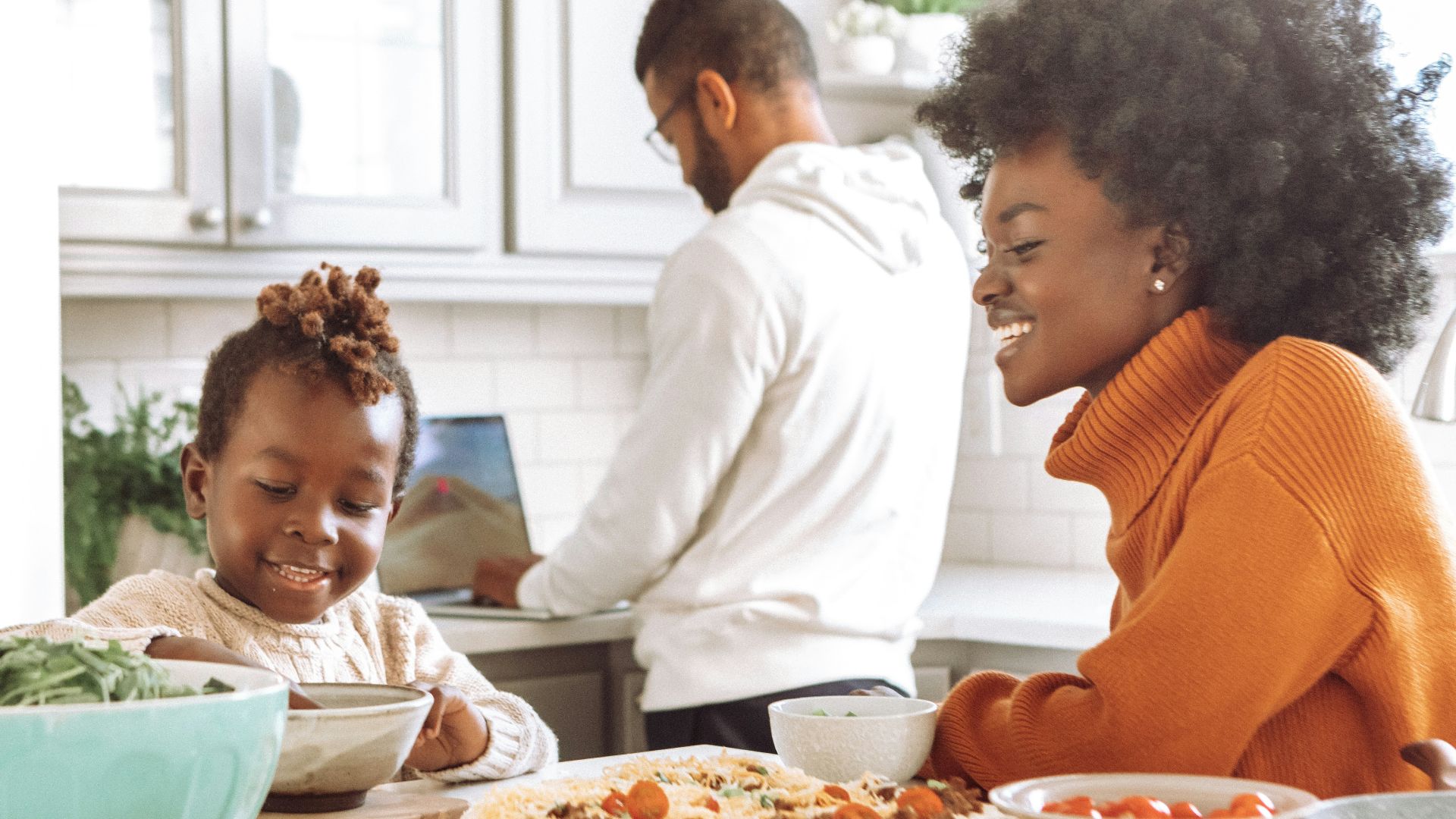 man in white dress shirt holding girl in red and white stripe dress