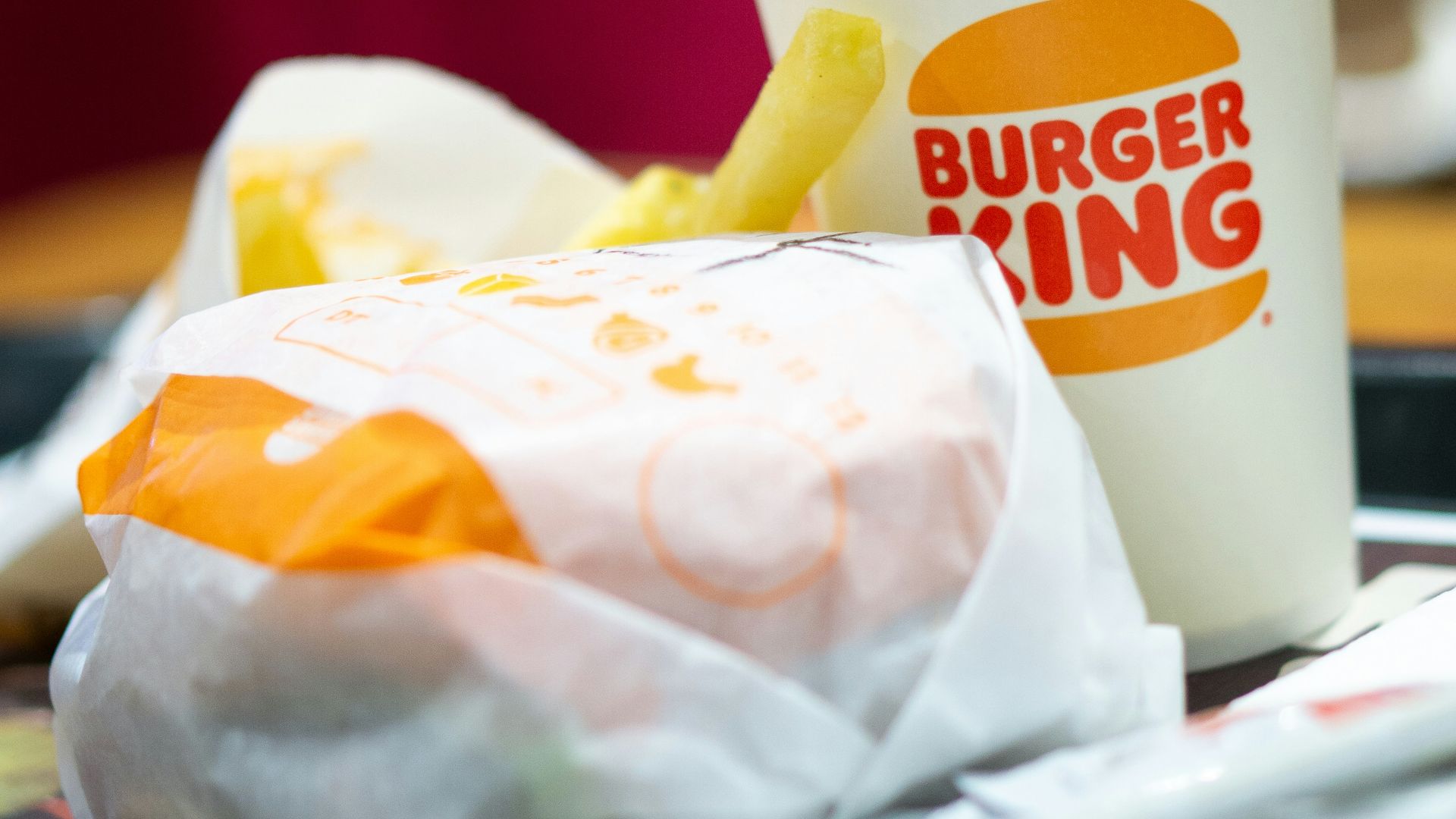 a burger king sandwich and a cup of coffee