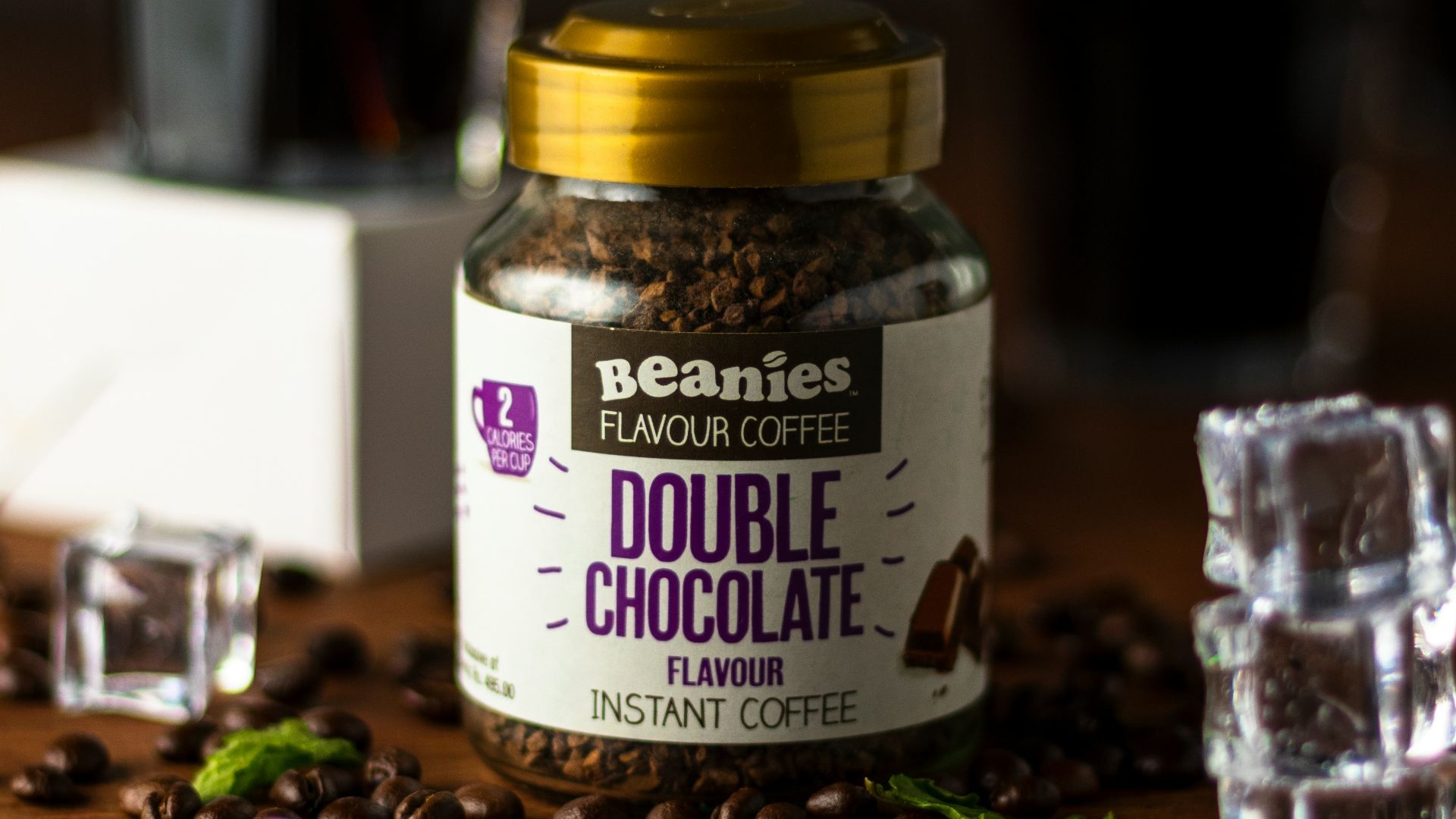 a jar of coffee sitting on top of a wooden table