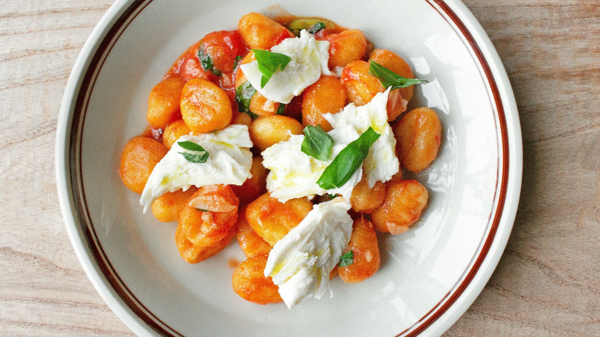 a white plate topped with food on top of a wooden table