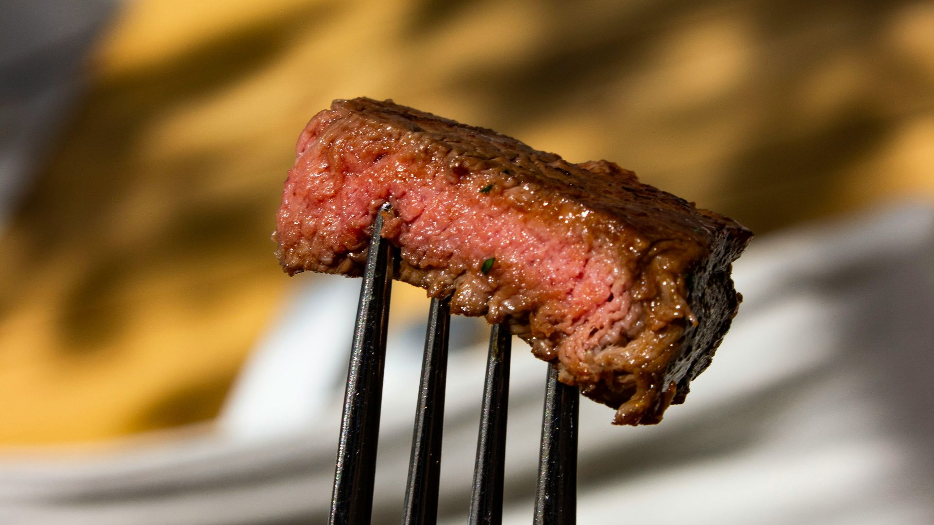 a fork with a piece of meat on it