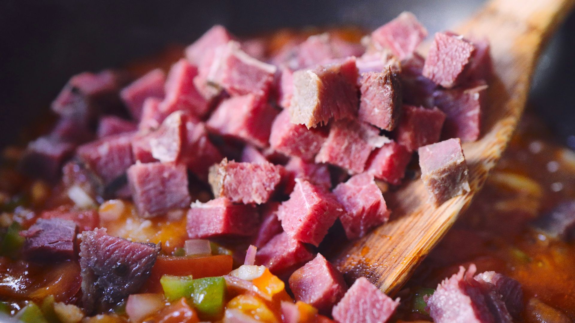 sliced meat on brown wooden chopping board