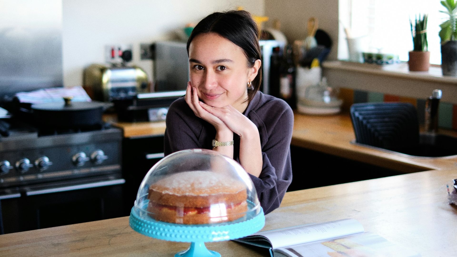woman in pink long sleeve shirt sitting at the table