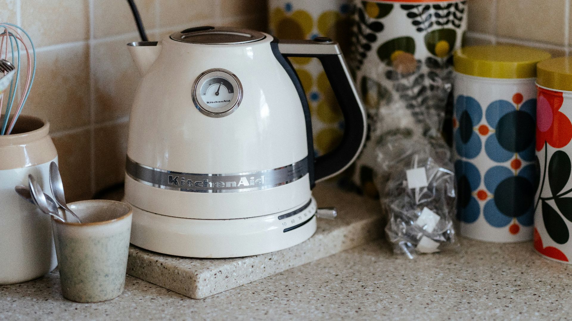 a white tea kettle sitting on top of a counter